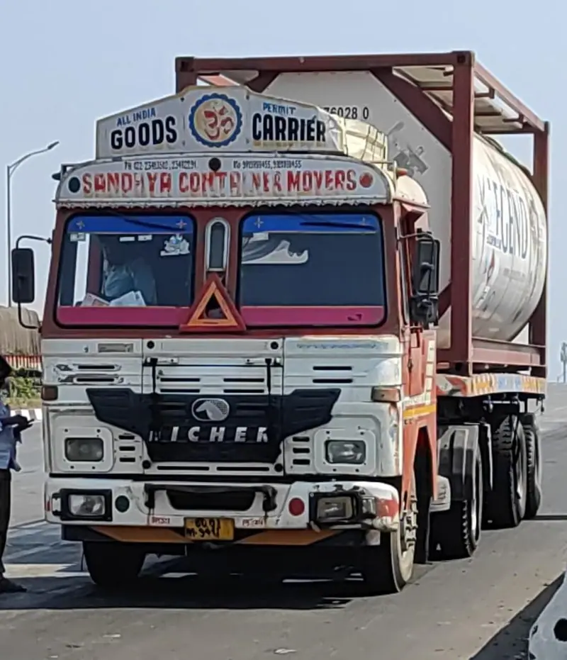 Front of a Sandhya Container Movers truck with an ISO tank container behind the cab
