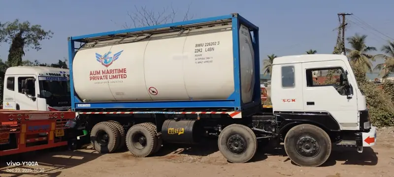 ISO tank container mounted on a trailer behind a white tractor unit