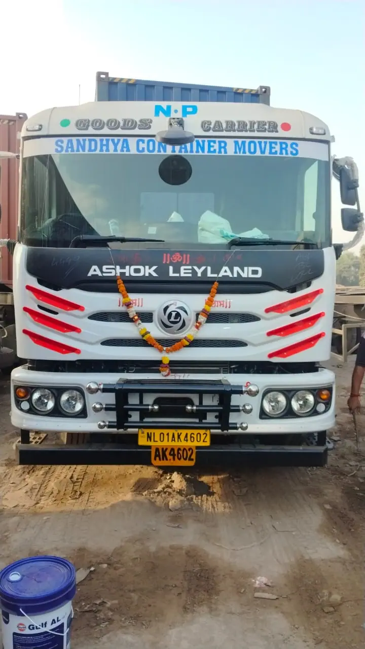 New white tractor unit with a garland across the grille