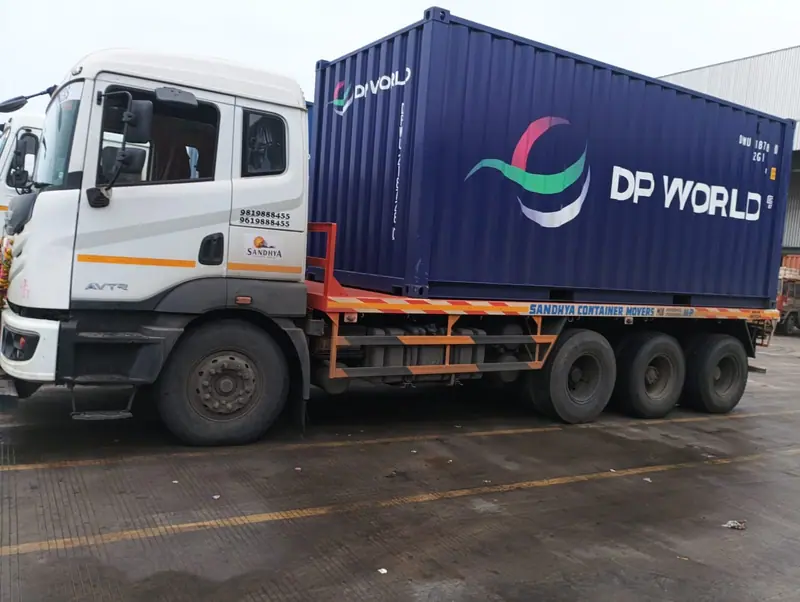 Sandhya-branded container truck carrying a blue 20ft shipping container