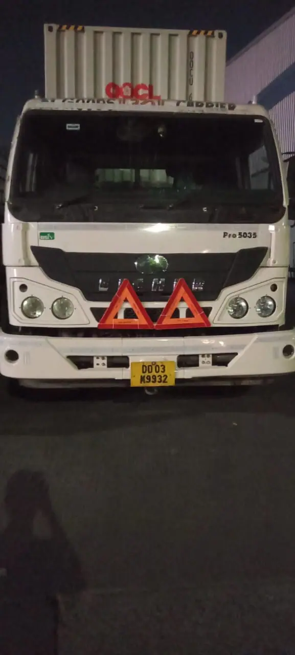 Truck carrying a container, photographed at night